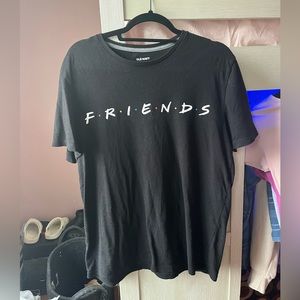This is a black tshirt that has friends written on it it is a woman’s M